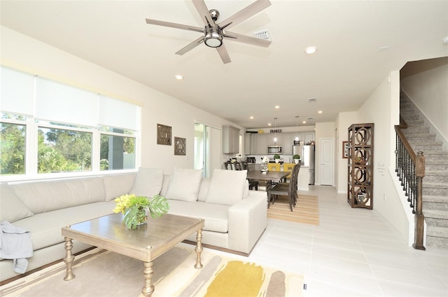 tiled living room with ceiling fan