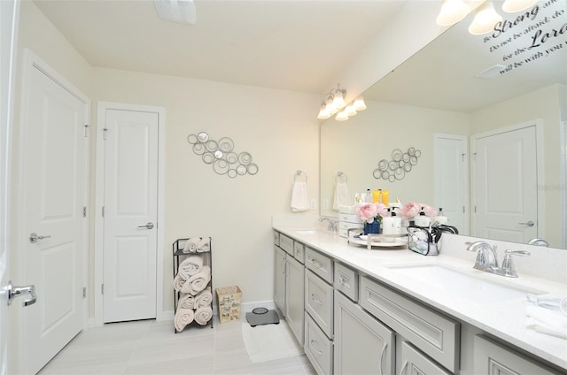 bathroom with tile patterned flooring and vanity