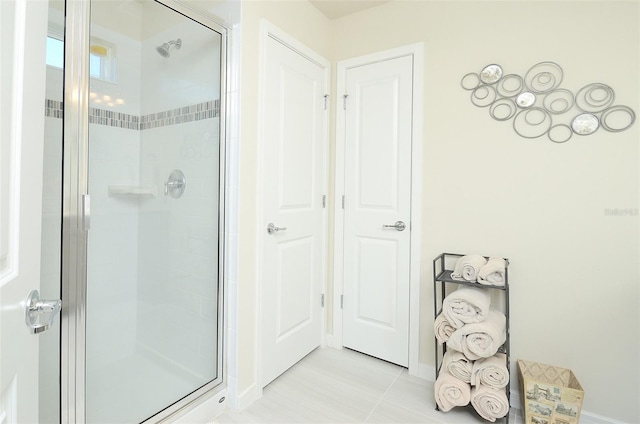 bathroom featuring tile patterned floors and a shower with door