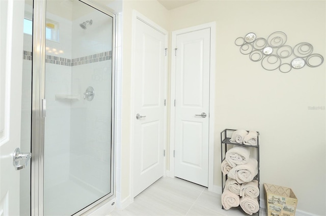 4963 Royal Point Ave, Kissimmee, FL 34746 - full bathroom with a stall shower, baseboards, and tile patterned floors