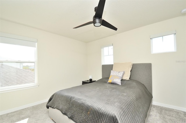 bedroom with light carpet and multiple windows