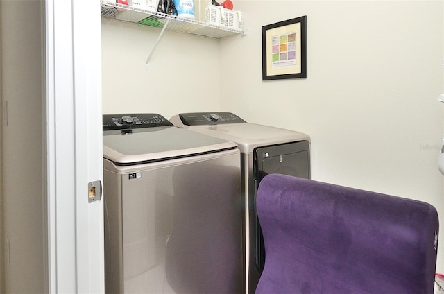 clothes washing area featuring independent washer and dryer