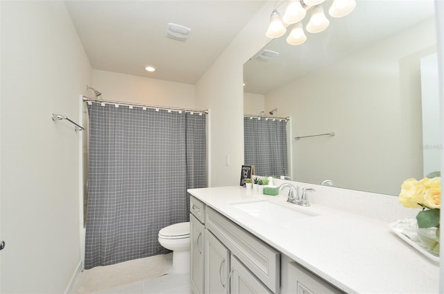 bathroom with a shower with curtain, vanity, toilet, and tile patterned floors