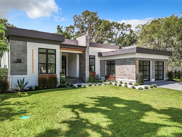 modern home featuring a front lawn