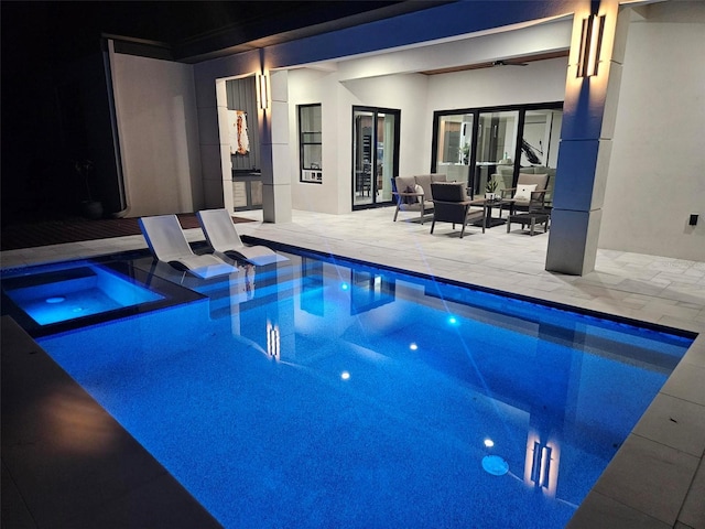 view of swimming pool featuring an in ground hot tub and a patio area