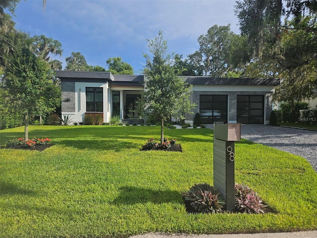 view of front of house with a garage and a front yard