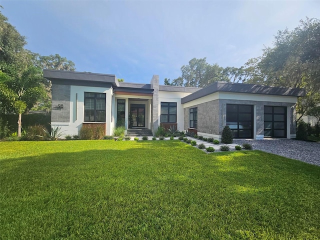 contemporary home with a garage and a front lawn