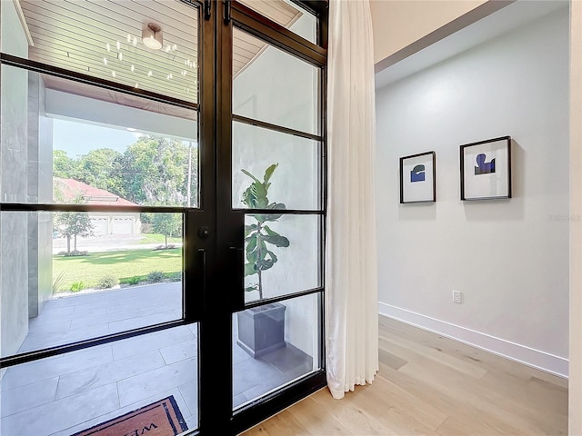 doorway to outside with light hardwood / wood-style flooring and french doors