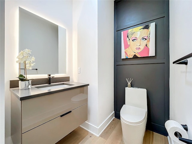 bathroom featuring hardwood / wood-style floors, vanity, and toilet