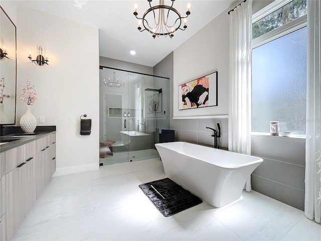 bathroom featuring a chandelier, vanity, shower with separate bathtub, and tile patterned flooring