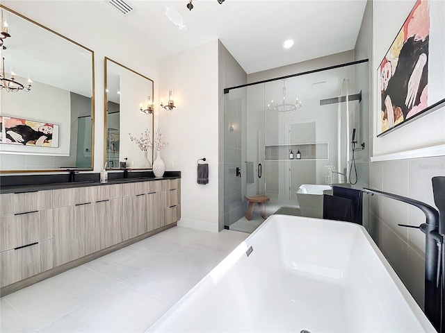 bathroom featuring vanity, independent shower and bath, tile patterned flooring, and an inviting chandelier