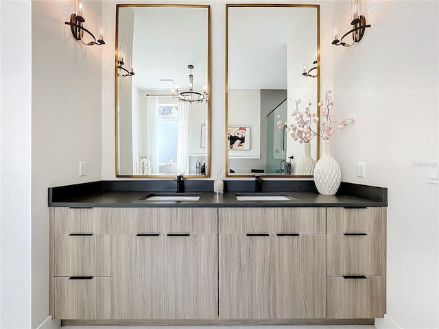 bathroom with vanity and an inviting chandelier