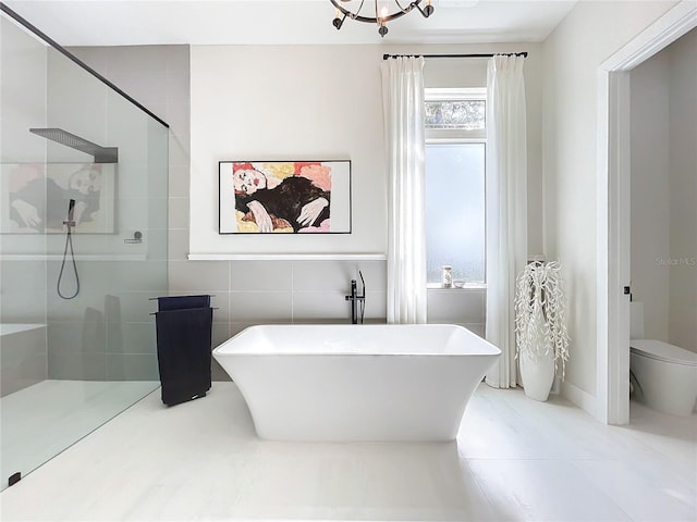 bathroom featuring toilet, shower with separate bathtub, tile patterned floors, and tile walls