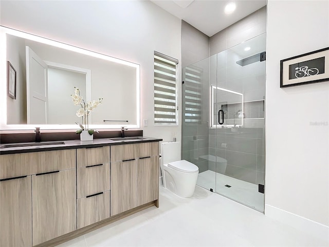 bathroom with toilet, tile patterned floors, vanity, and a shower with door