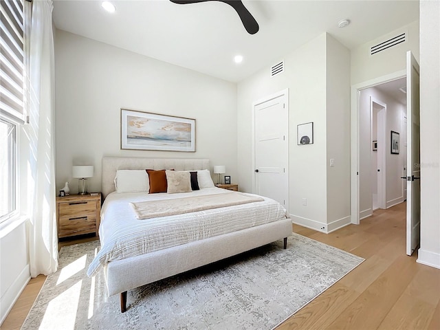 bedroom with ceiling fan and light hardwood / wood-style floors