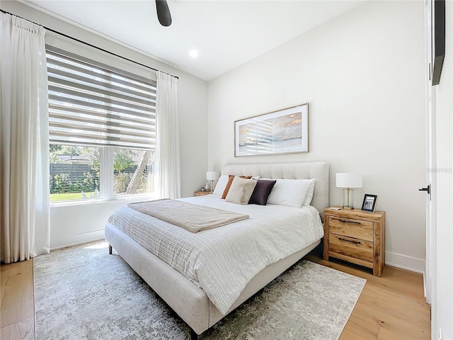 bedroom featuring ceiling fan and light hardwood / wood-style flooring