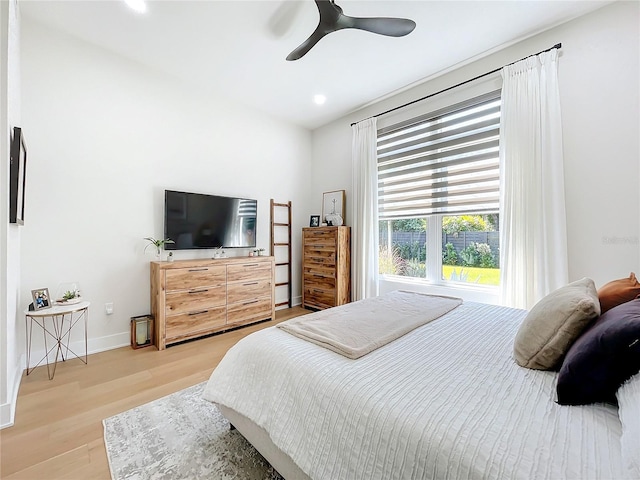 bedroom with ceiling fan and light wood-type flooring