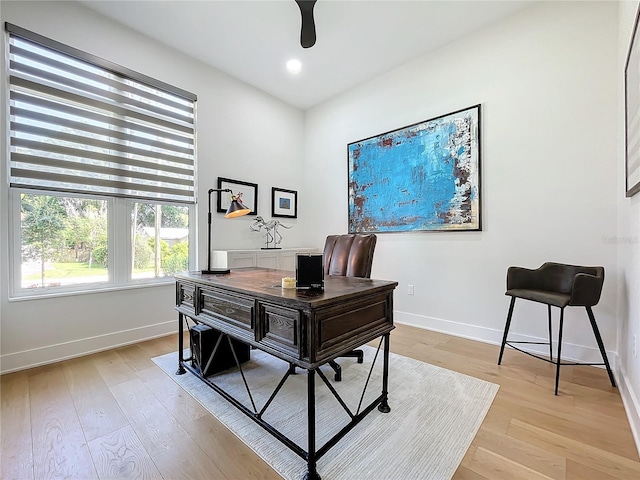 home office with light hardwood / wood-style floors