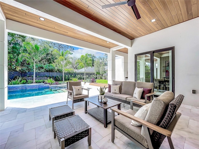 view of patio / terrace with outdoor lounge area, ceiling fan, pool water feature, and a fenced in pool