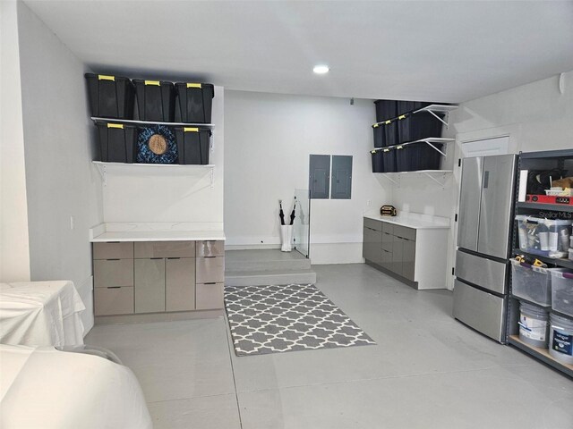 bathroom with electric panel and concrete floors