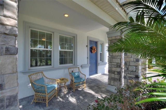 view of exterior entry with covered porch