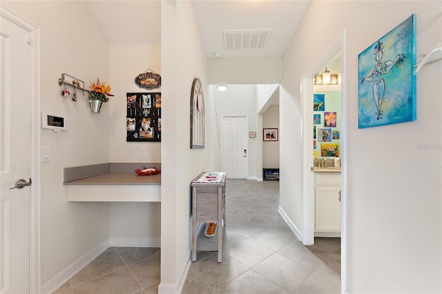 corridor featuring light tile patterned floors