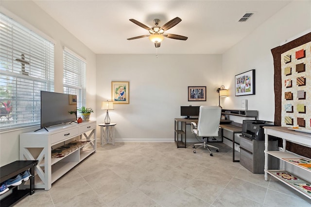 tiled office space featuring ceiling fan