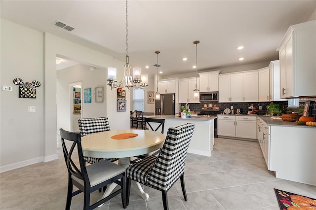 dining room featuring light tile patterned floors and an inviting chandelier