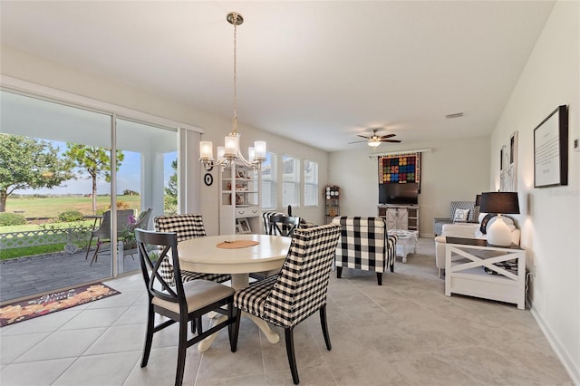 dining room with ceiling fan with notable chandelier and light tile patterned floors