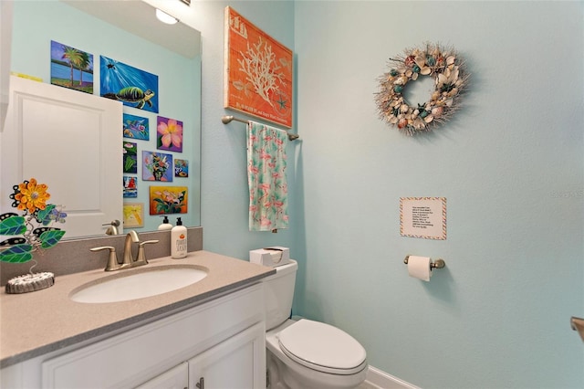 bathroom featuring toilet and vanity