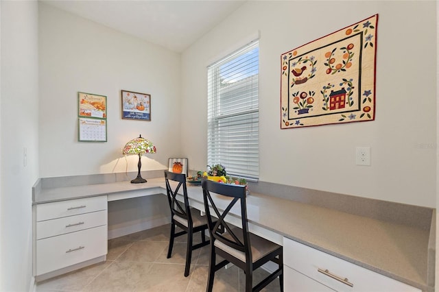 office space featuring light tile patterned flooring and built in desk