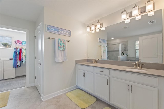 bathroom featuring vanity, tile patterned floors, and an enclosed shower