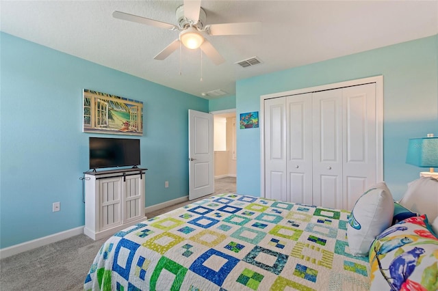 carpeted bedroom with ceiling fan and a closet