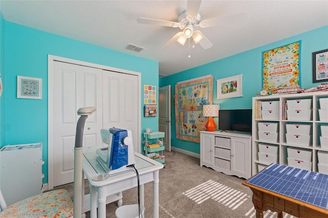 interior space featuring ceiling fan and light carpet