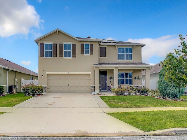 view of front facade featuring a garage and a front lawn