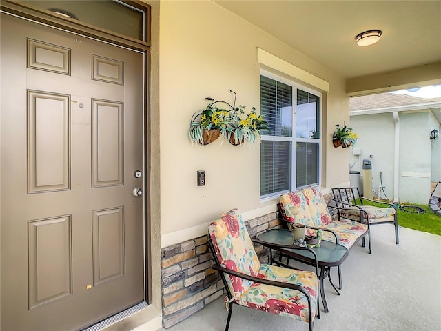 1927 Partin Terrace Rd, Kissimmee, FL 34744 - view of exterior entry with stucco siding and a porch