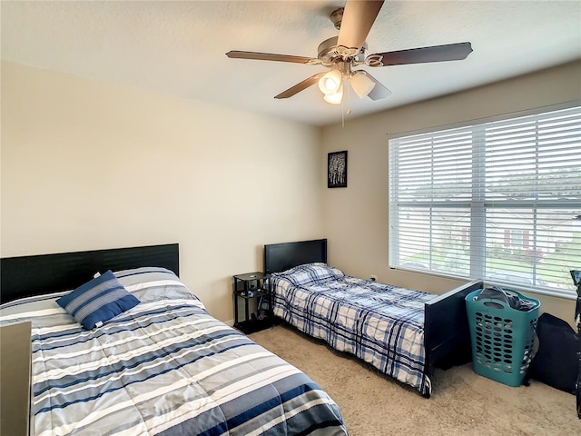 bedroom featuring ceiling fan and light carpet