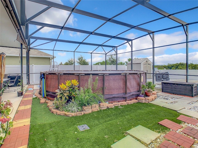 view of yard featuring a storage shed, a swimming pool with hot tub, glass enclosure, and a patio area