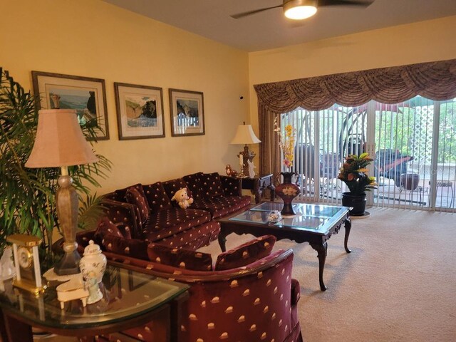 carpeted living room featuring ceiling fan