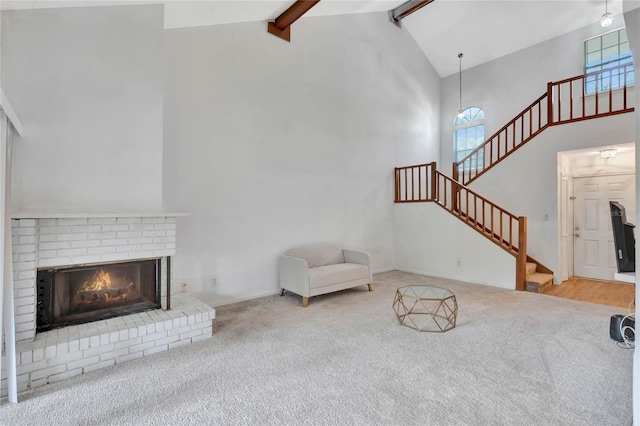 unfurnished living room featuring beamed ceiling, carpet floors, high vaulted ceiling, and a brick fireplace