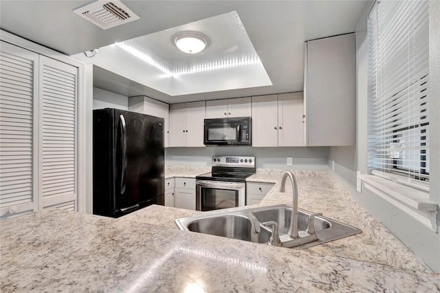 kitchen with white cabinets, sink, and black appliances