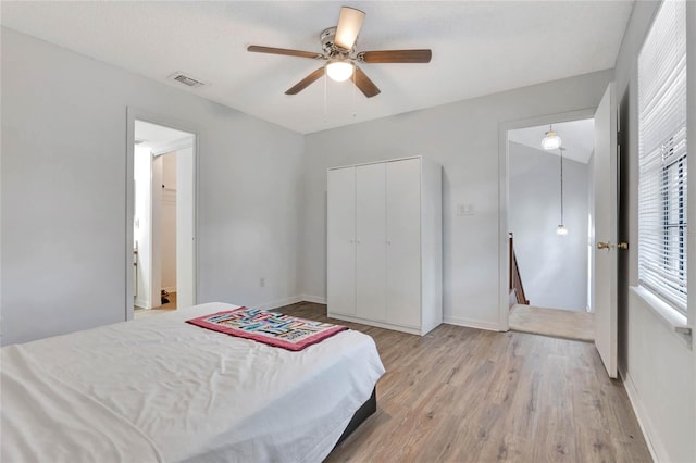 bedroom with ceiling fan, a closet, and light wood-type flooring