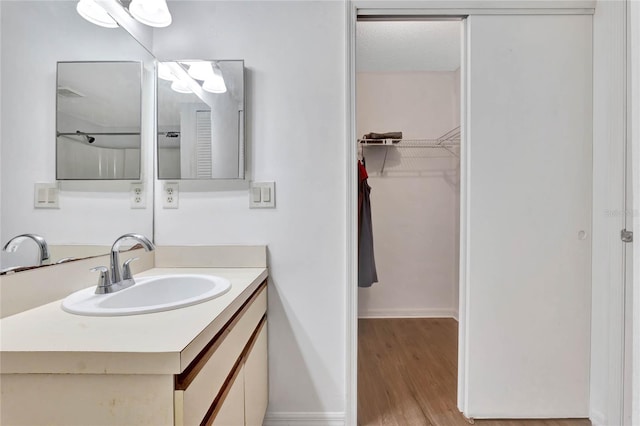 bathroom with hardwood / wood-style floors and vanity