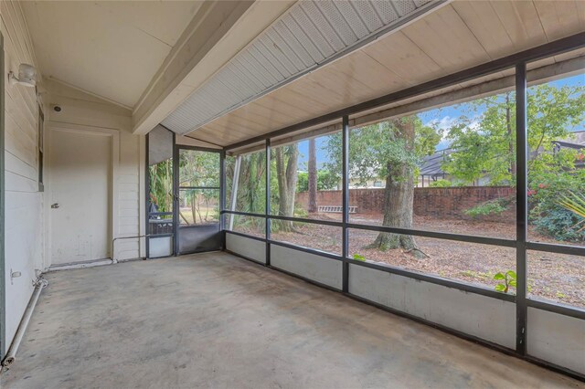 unfurnished sunroom featuring lofted ceiling