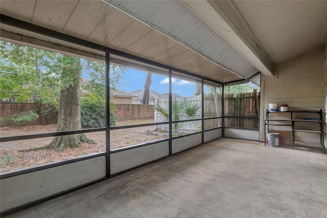 unfurnished sunroom with vaulted ceiling