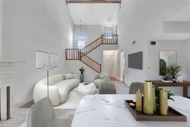 living room featuring a towering ceiling