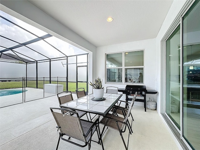 view of patio featuring a lanai