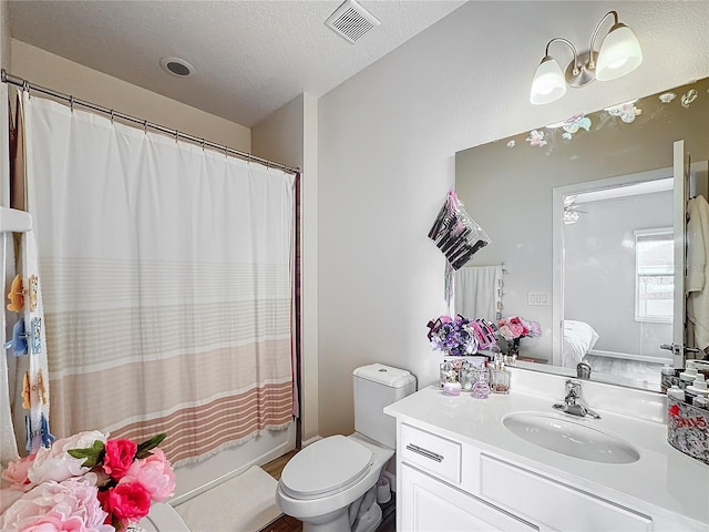 full bathroom featuring vanity, toilet, shower / bathtub combination with curtain, and a textured ceiling