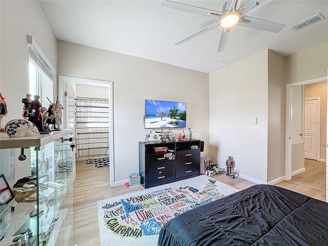 bedroom featuring wood-type flooring, a textured ceiling, and ceiling fan