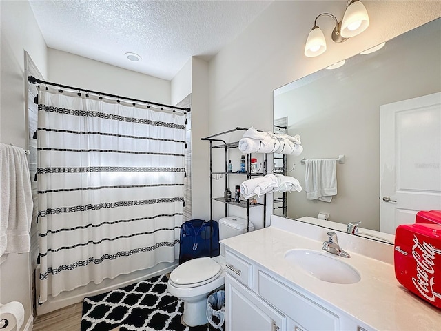 full bathroom with shower / bath combination with curtain, vanity, a textured ceiling, hardwood / wood-style floors, and toilet